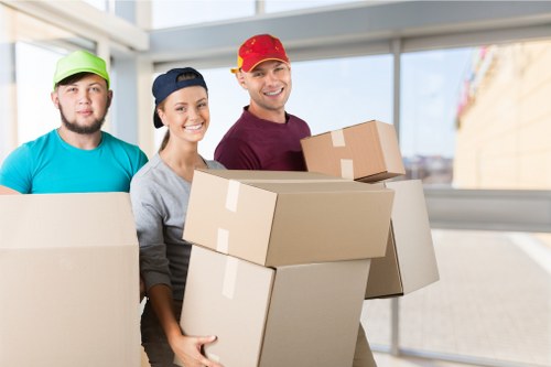Professional movers loading household items for a West Kensington home move