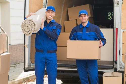 Packed moving boxes and furniture prepared for a West Kensington home move