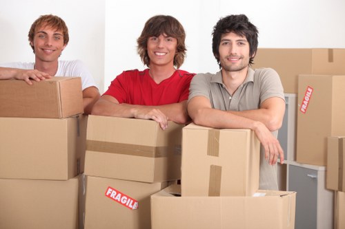 Removal staff carrying items using proper manual handling techniques