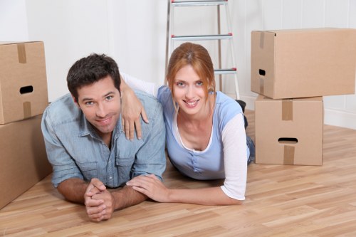 Local movers handling boxes and household items in a West Kensington flat