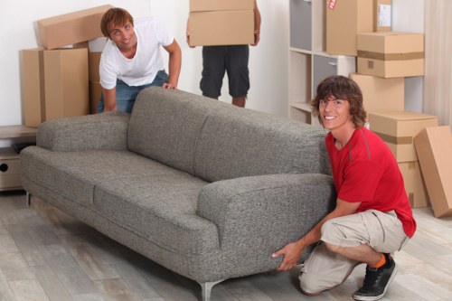 Furniture being carefully carried during a local move in West Kensington