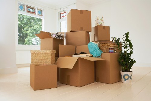 Prepared moving boxes and wrapped furniture ready for a West Kensington removal