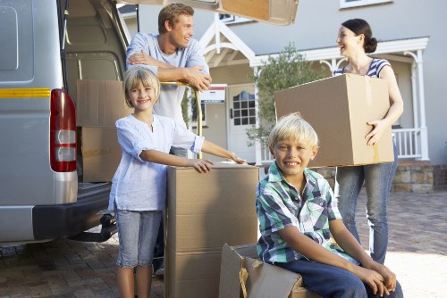 Loading furniture into a van for a local move in West Kensington